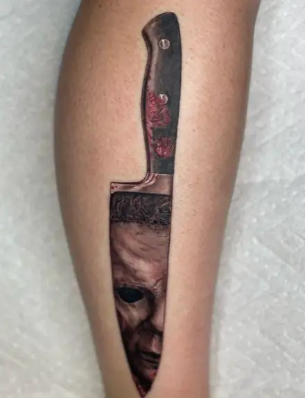 Bloody Knife with Michael Myers Face on Blade Forearm Tattoo