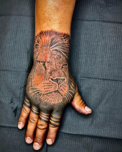 Black and Grey Realistic Lion Head Hand Tattoo