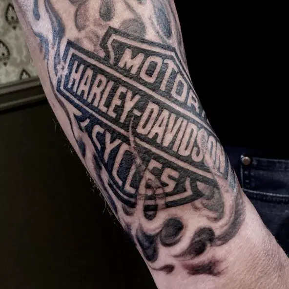 Black and Grey Smokey Harley Davidson Logo Forearm Tattoo
