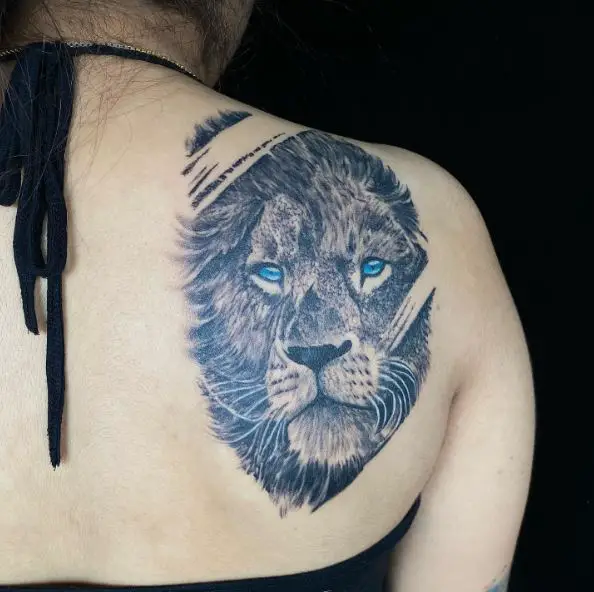 Black and Grey Realistic Lion Head with Blue Eyes Back Tattoo