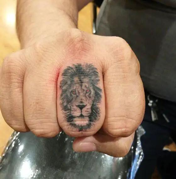 Minimalistic Lion Head with Red Eyes Finger Tattoo