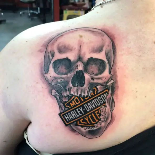Black and Grey Skull and Colorful Harley Davidson Logo Back Tattoo