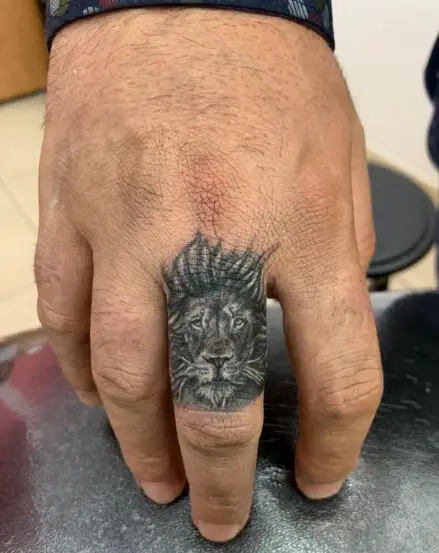 Minimalistic Lion Head Finger Tattoo
