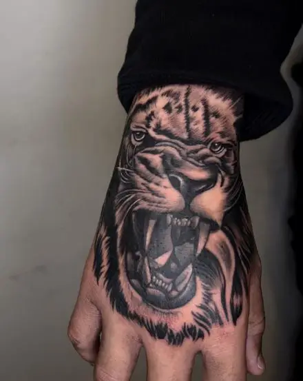 Realistic Roaring Lion Hand Tattoo