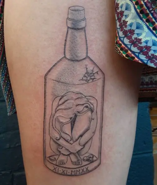 Crouched Girl inside Bottle with Date Sobriety Thigh Tattoo