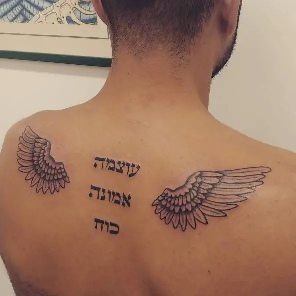 Black and Grey Hebrew Lettering and Angel Wings Back Tattoo