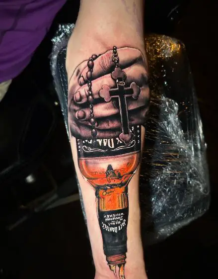 Hands with Cross and Jack Daniels Bottle Forearm Tattoo