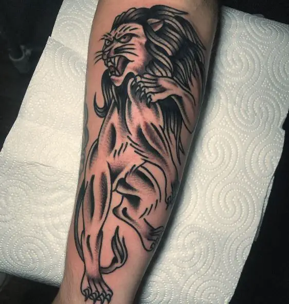 Black and Grey Traditional Fighting Lion Forearm Tattoo