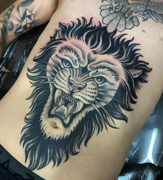 Black and Grey Roaring Traditional Lion Stomach Tattoo