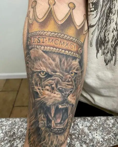 Roaring Lion with Golden Crown Forearm Tattoo