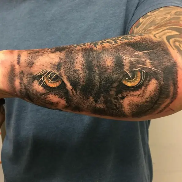 Black and Grey Mountain Lion's Eyes Forearm Tattoo