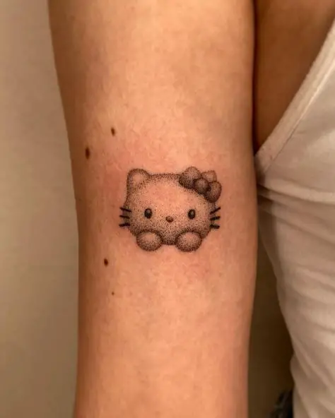 Black and Grey Shaded Hello Kitty Head Biceps Tattoo
