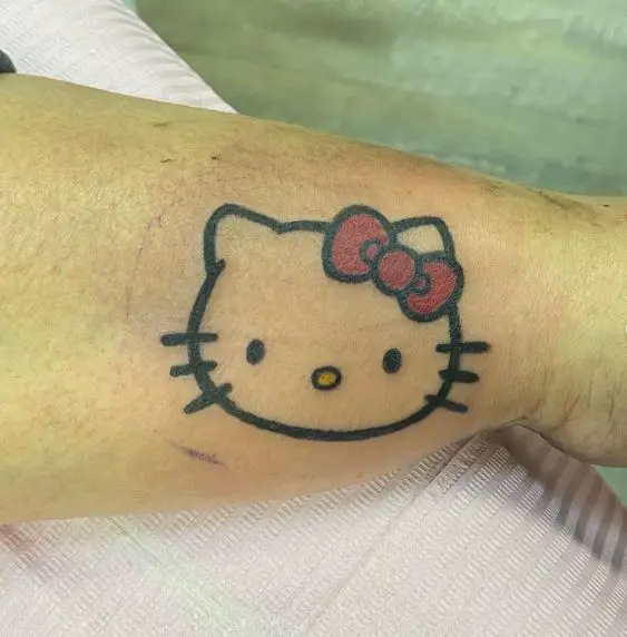 Minimalistic Hello Kitty Head with Red Bow Wrist Tattoo