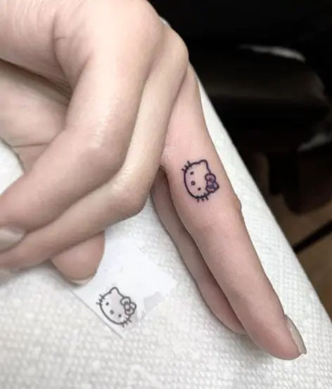 Minimalistic Hello Kitty Head with Red Bow Finger Tattoo