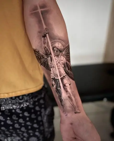 Black and Grey Saint Michael with Cross and Wings Forearm Tattoo