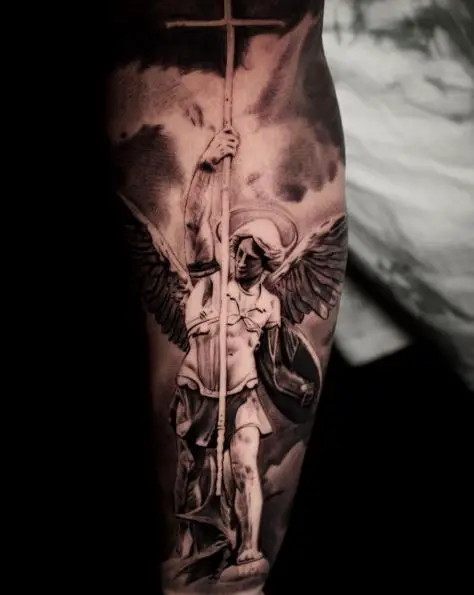 Black and Grey Saint Michael with Cross, Shield and Wings Forearm Tattoo