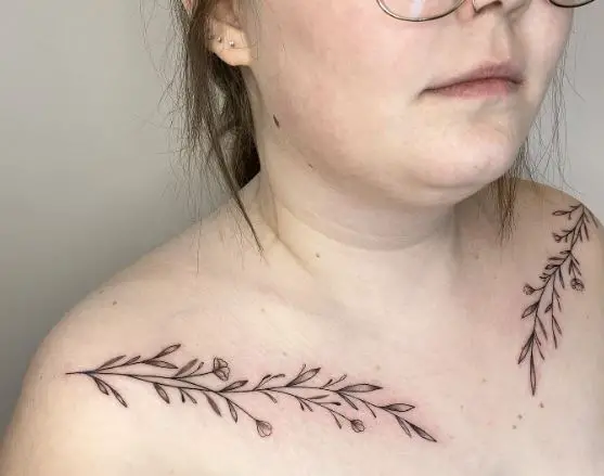 Black and Grey Branches with Leaves and Flowers Collarbone Tattoo
