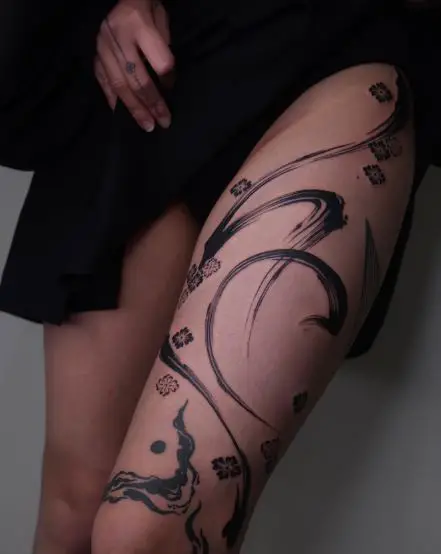 Black Brush Stroke with Floral Pattern Abstract Thigh Tattoo