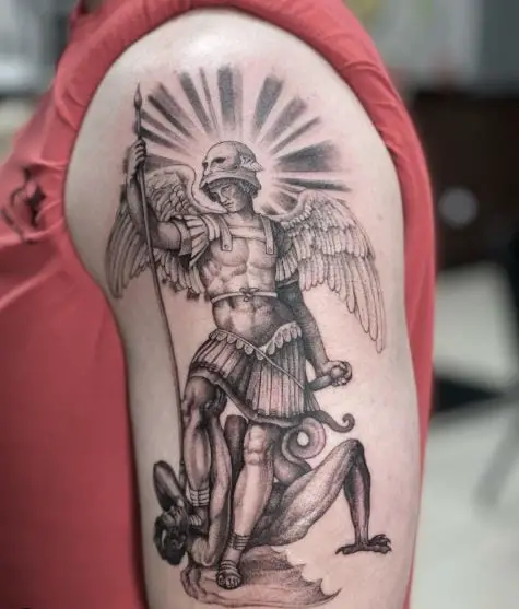 Black and Grey Saint Michael with Helmet and Spear Defeating Satan Arm Tattoo