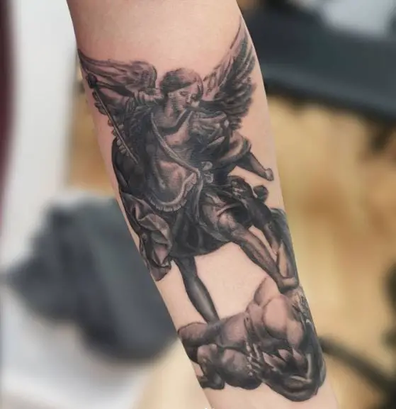 Black and Grey Saint Michael with Sword Defeating Satan Forearm Tattoo