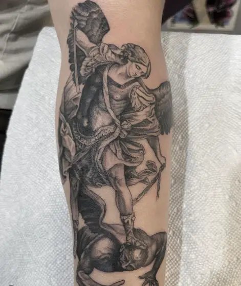Black and Grey Saint Michael with Sword Defeating Satan Leg Tattoo
