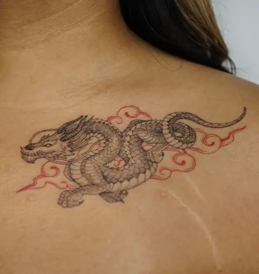 Red Clouds and Grey Dragon Collarbone Tattoo