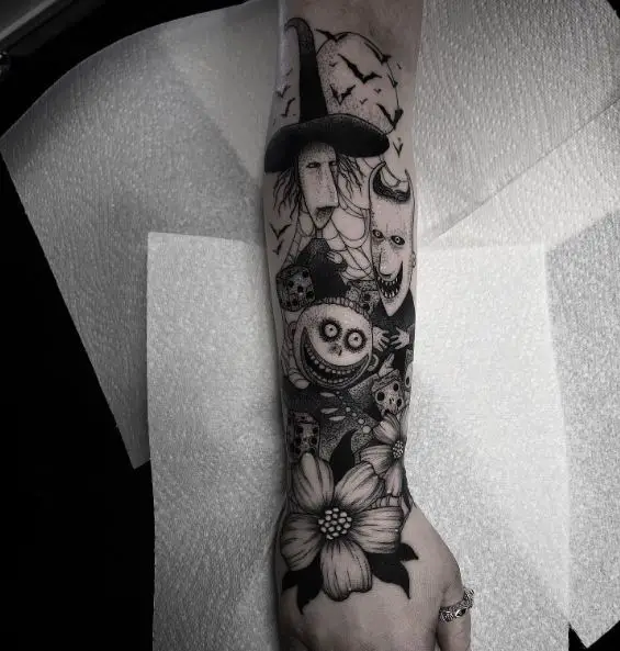 Black and Grey Bats and Lock, Shock and Barrel, with Flower Forearm Tattoo
