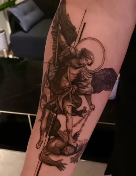 Black and Grey Saint Michael with Sword and Chain Defeating Satan Forearm Tattoo