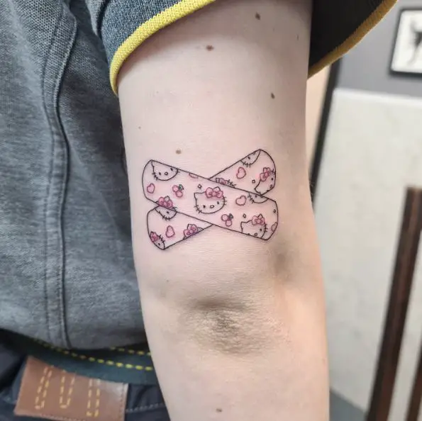 Black and Pink Hello Kitty Band-Aid with Hearts Above Elbow Tattoo