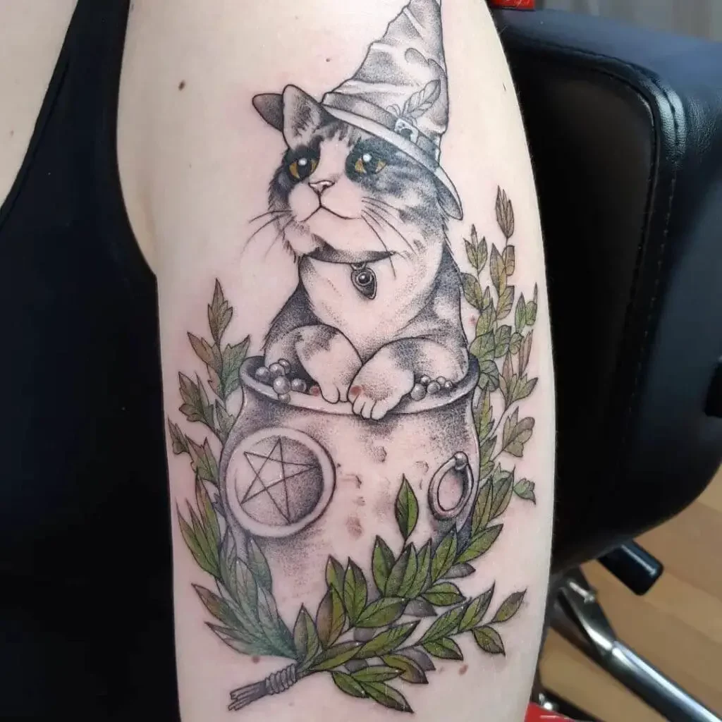 A Cat Wearing A Witch's Hat is Sitting in a Cauldron Tattoo