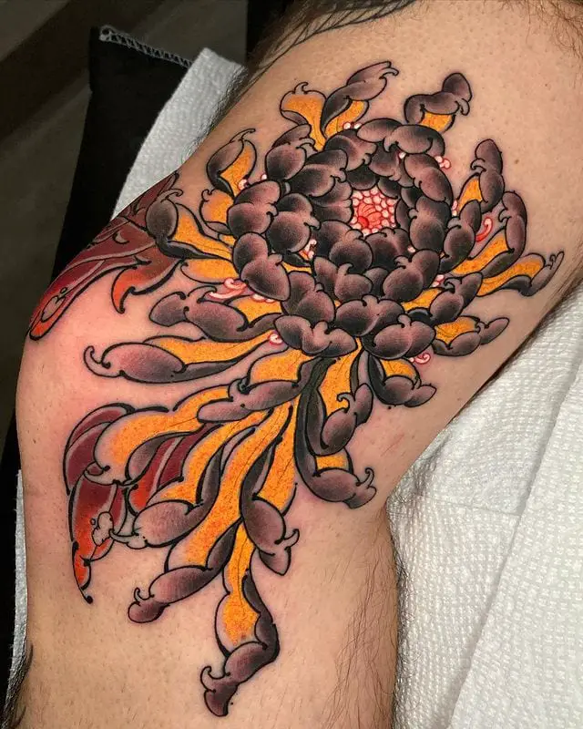 A Deep Brown Chrysanthemum Flower Spider Style Leg Tattoo