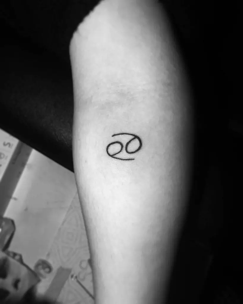 Black Minimalist Cancer Zodiac Sign Arm Tattoo