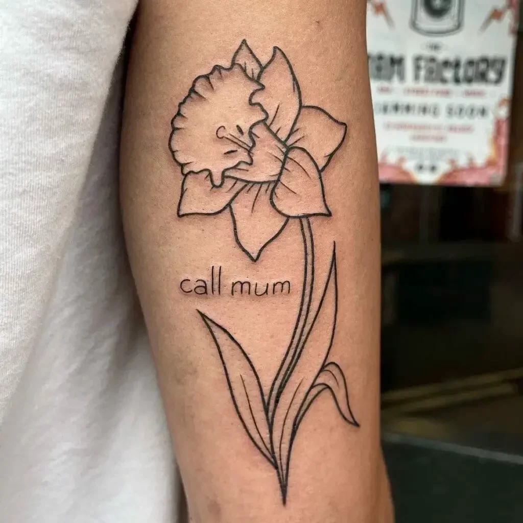Simple Line Daffodils Flower With Phrase Arm Tattoo