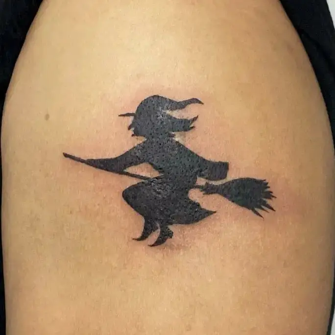 Solid Black Witch Riding a Broom Tattoo