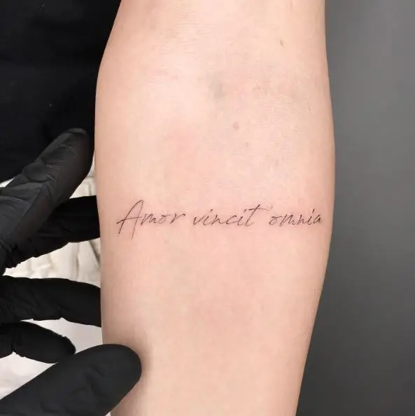 Amor Vincit Omnia Cursive Font Tattoo