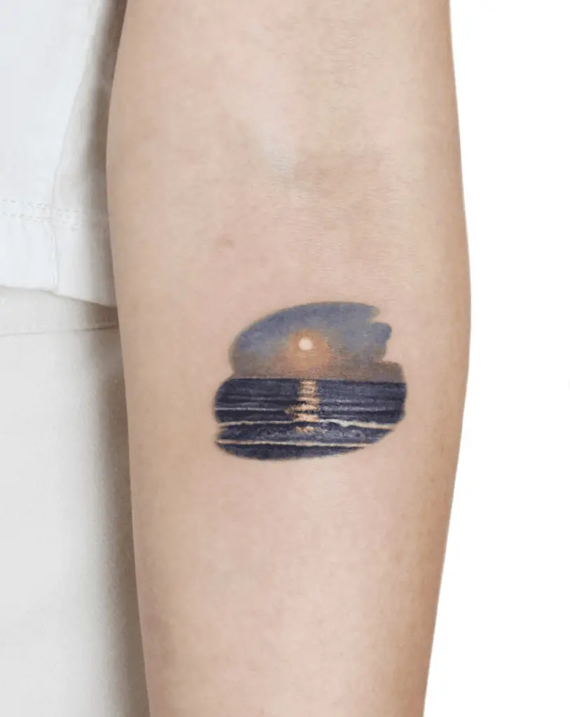 Colored Sunset and Calm Waves Arm Tattoo