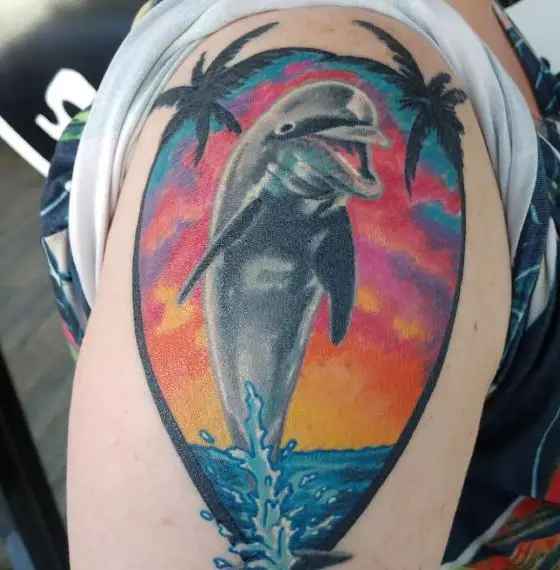 Dolphin and Ocean Themed Arm Tattoo