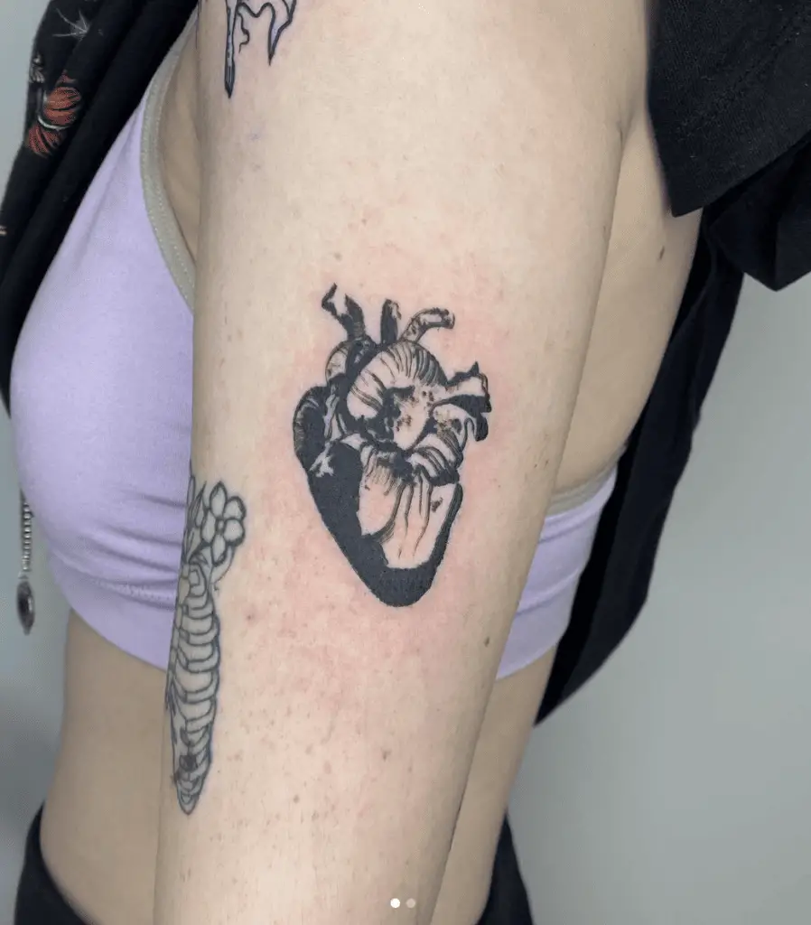 Human Heart Negative Space Arm Tattoo