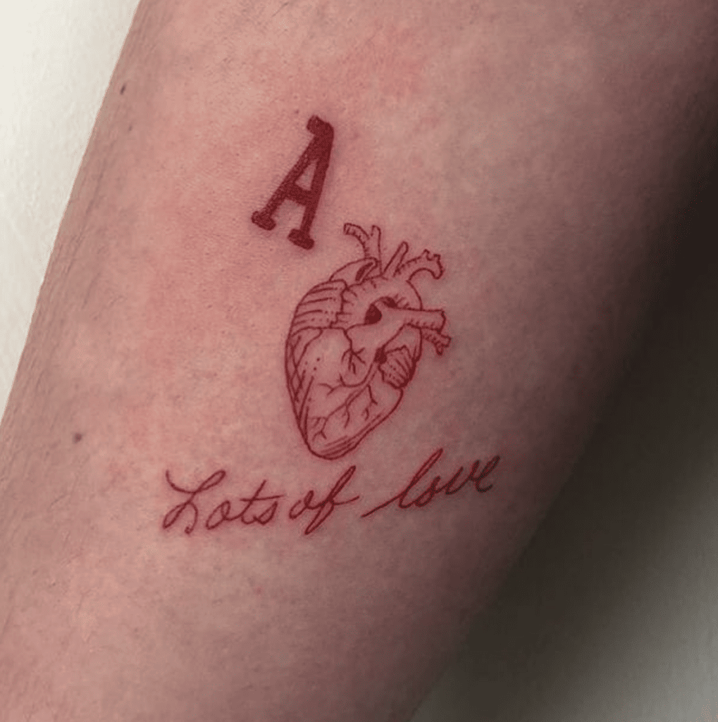 Human Heart With a Letter and Phrase Red Tattoo