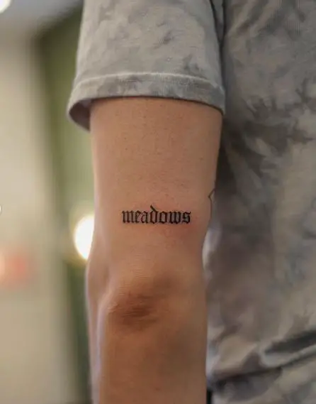 Meadows Single Word Arm Tattoo