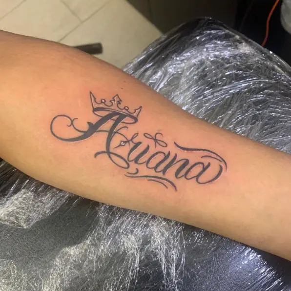 Name Tattoo with a Crown Forearm Tattoo