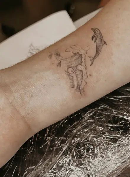 Sea Waves and Dolphin Wrist Tattoo