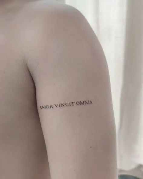 Simple Amor Vincit Omnia Lettering Arm Tattoo