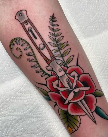 Switchblade with a Flower Forearm Tattoo