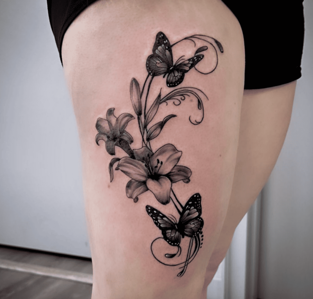Two Butterflies Flying Around Lilies Flower Tattoo