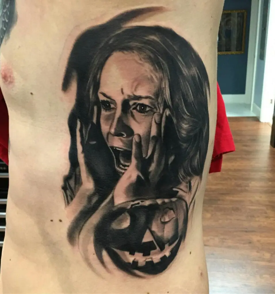 A Woman Screaming With Halloween Pumpkin Rib Tattoo