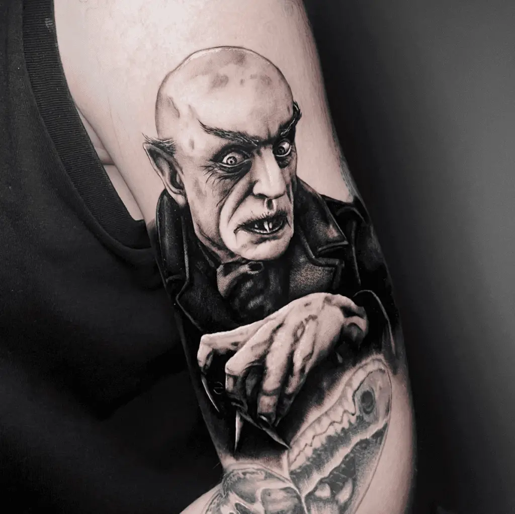 Bald Vampire Man Looking Away Arm Tattoo