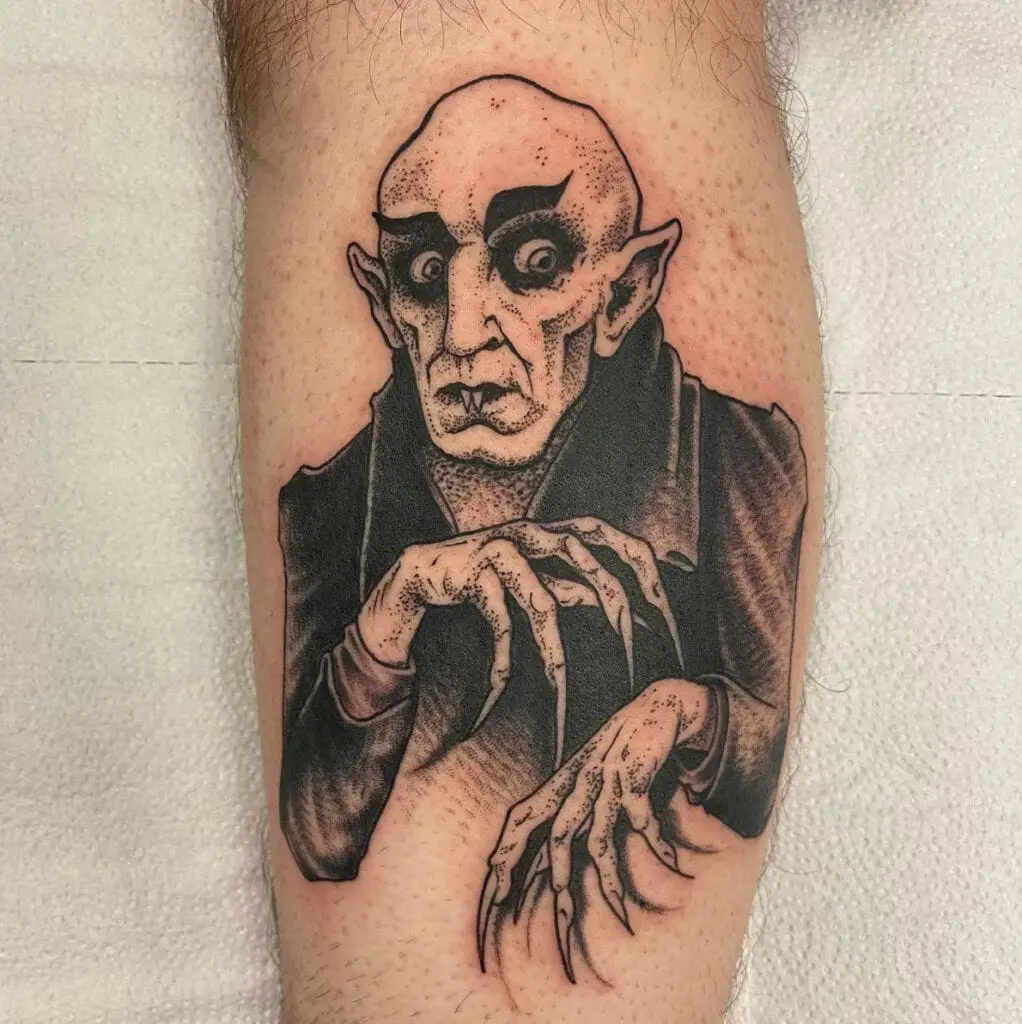 Bald Vampire Man With Thick Brows Long Nails and Pointed Ears Leg Tattoo
