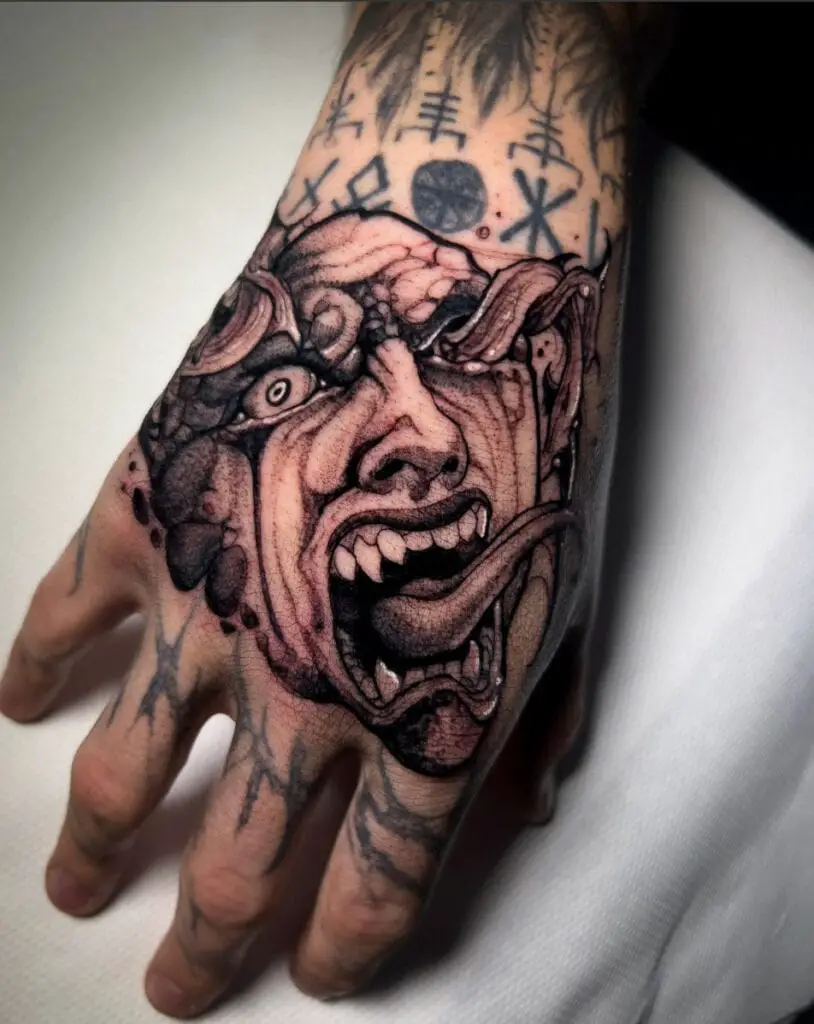 Behelit Long Tounge and Sharp Teeth Terrifying Art Hand Tattoo