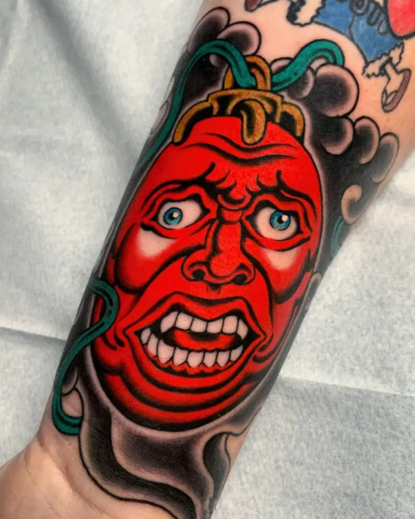 Behelit Making Crazy Face Japanese Arm Tattoo